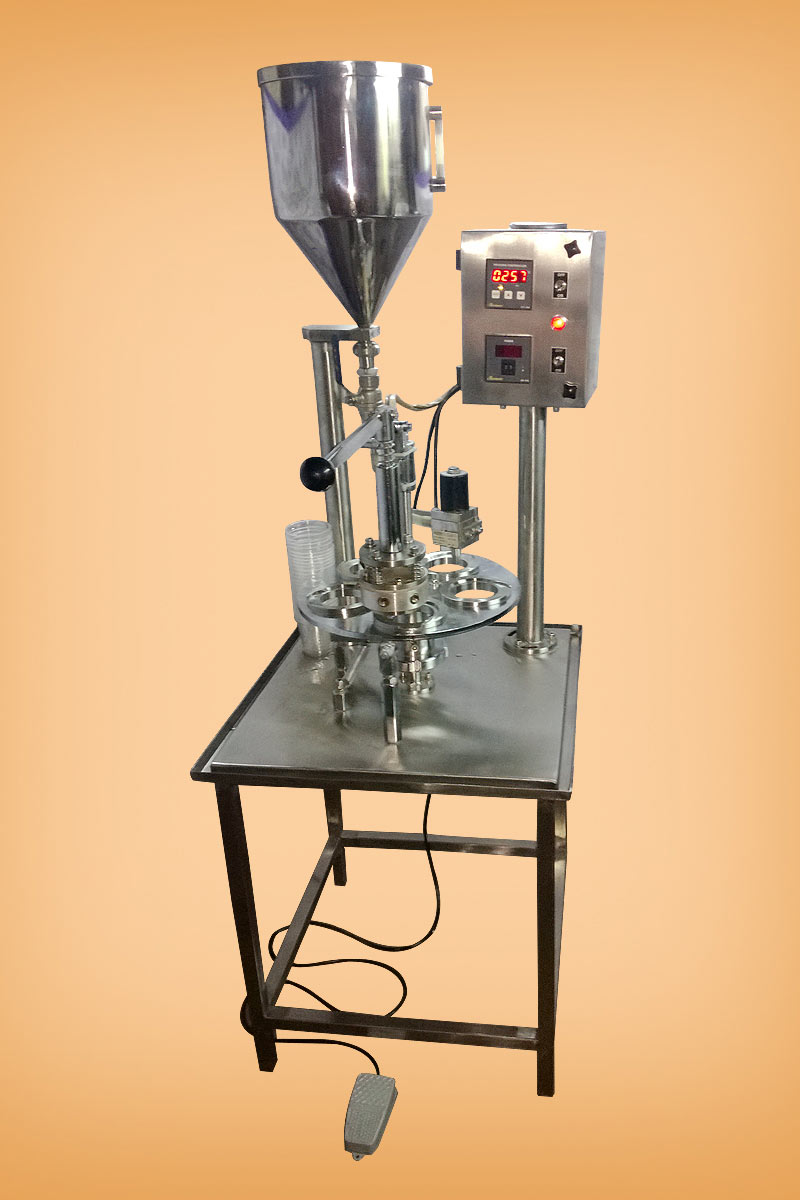 Foot operated cup filling and sealing machine